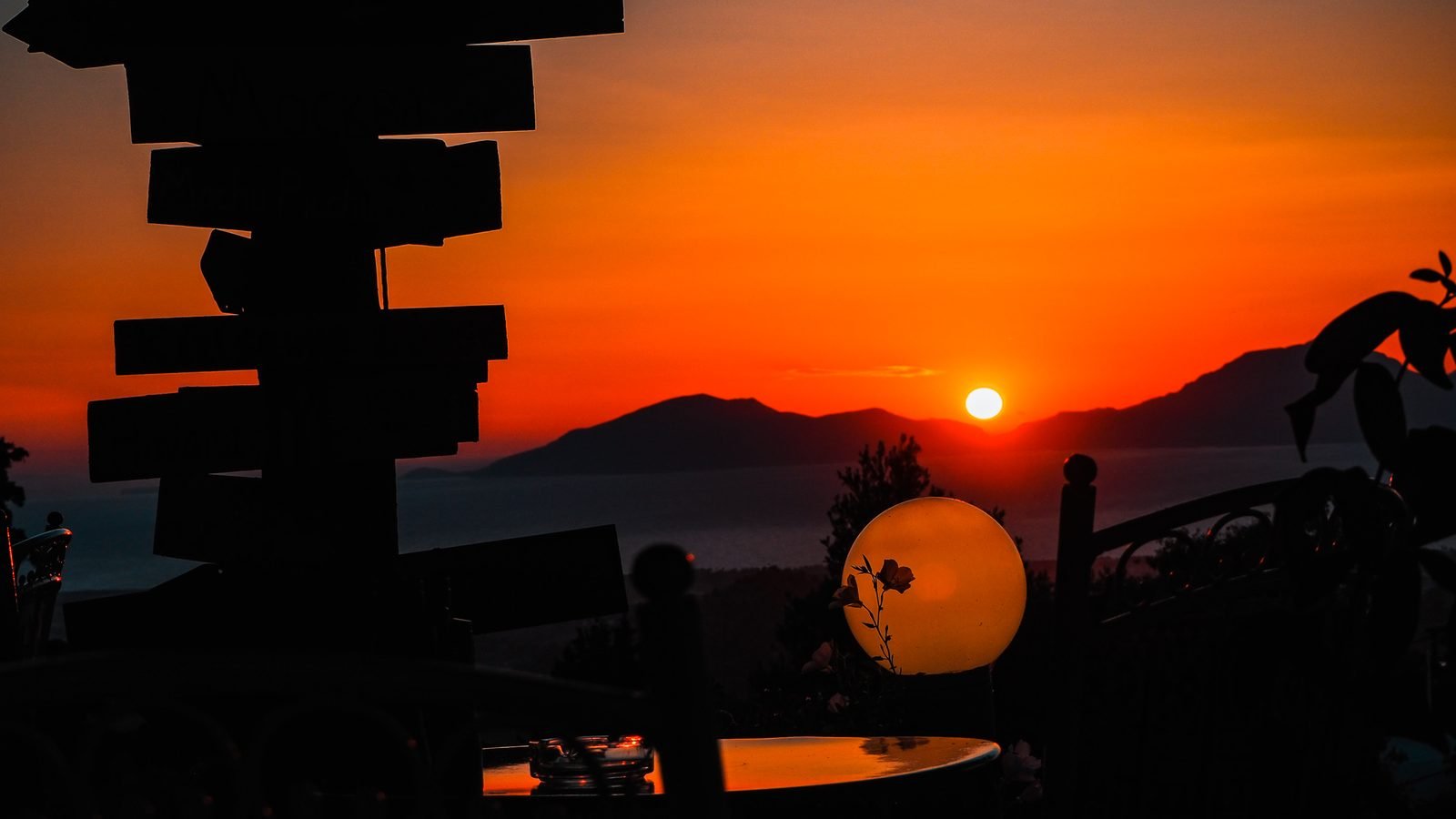 Sunset seen from Zia on Kos, with the sun dropping behind the hills